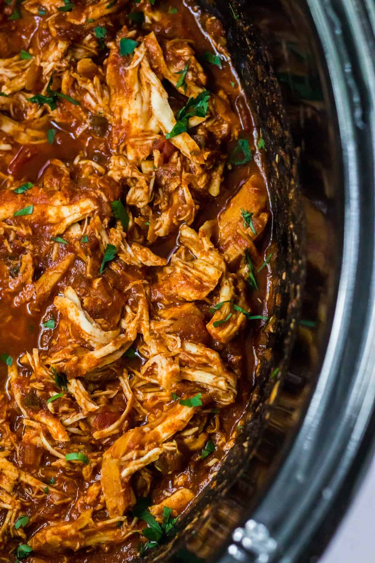 Slow cooker shredded chicken with taco seasoning and salsa.