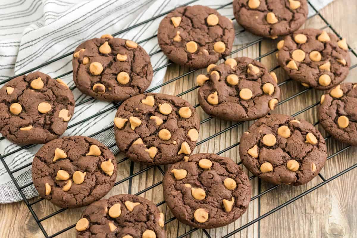 Chocolate peanut butter chip cookies on cooling rack.