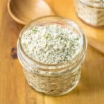Homemade ranch seasoning mix with buttermilk powder in a small glass jar.