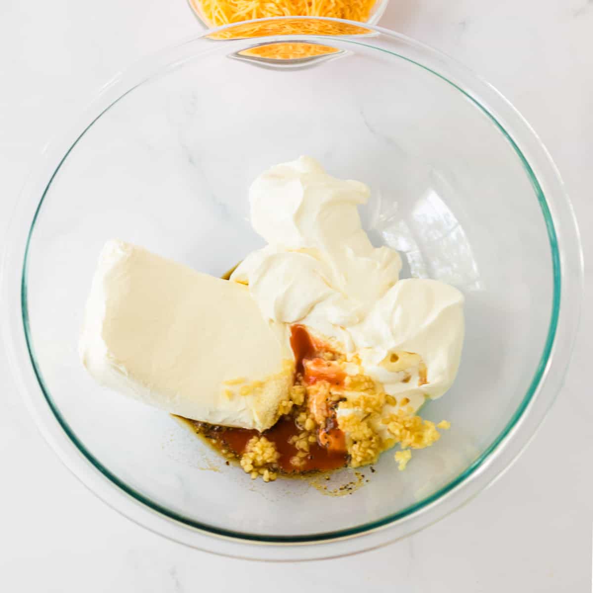 Cream cheese, sour cream, garlic, onion poweder, pepper, hot sauce. and Worcestershire sauce in a mixing bowl.