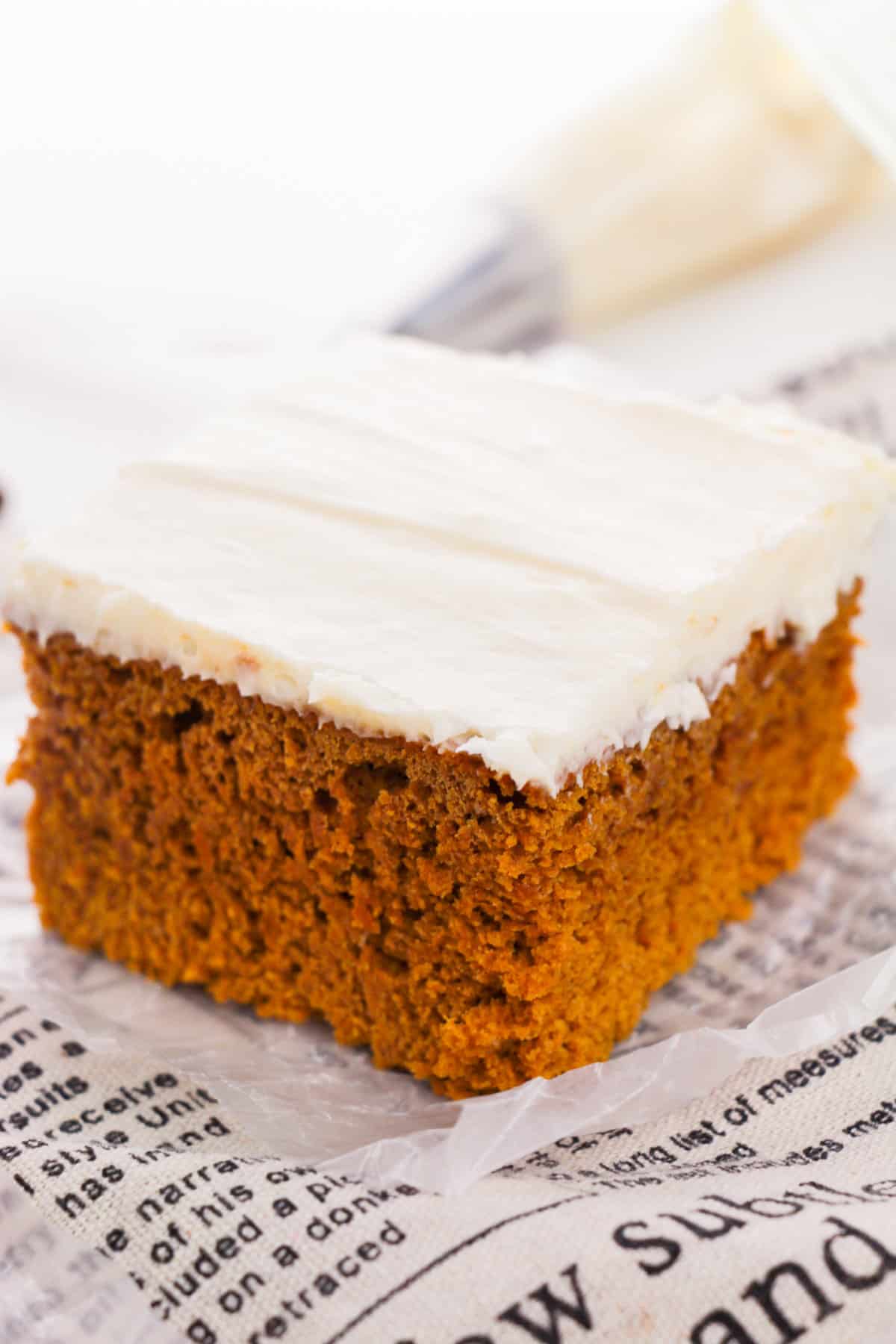 Pumpkin spice cake made with pumpkin puree and spice cake mix and topped with cream cheese frosting.