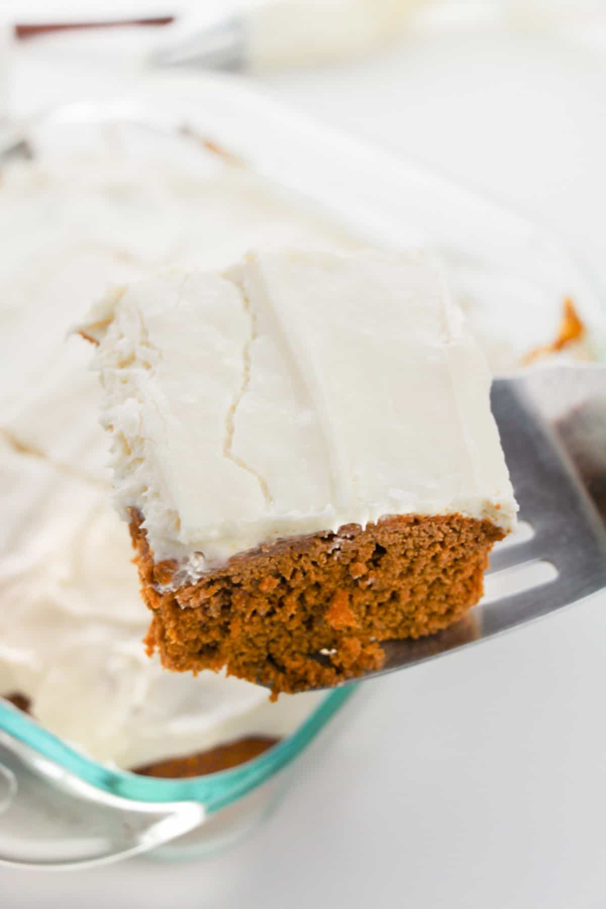 Spatula serving a piece of pumpkin spice cake.