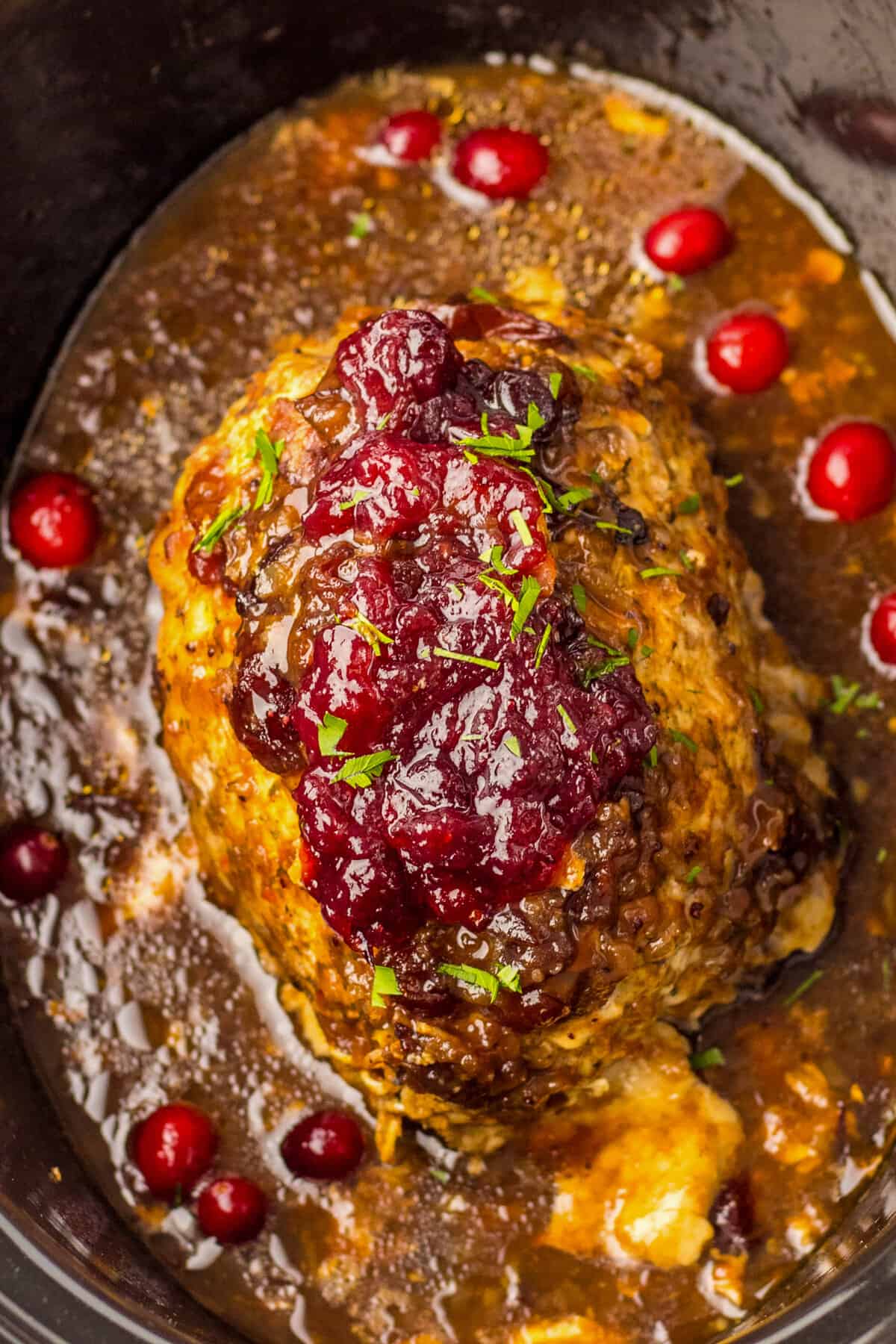Slow Cooker boneless turkey breast roast cooked in cranberry sauce.