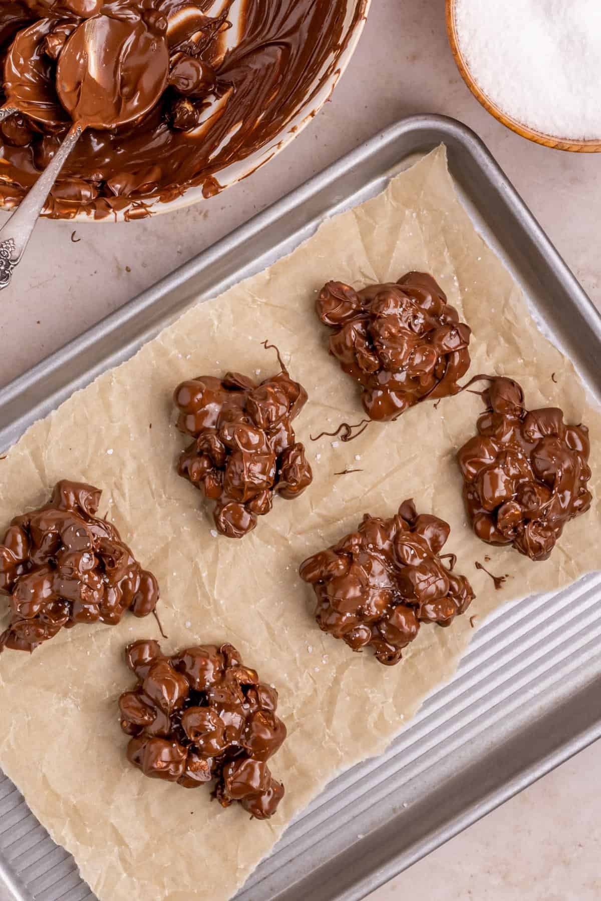 Rocky Road candy topped with salt on lined baking sheet.
