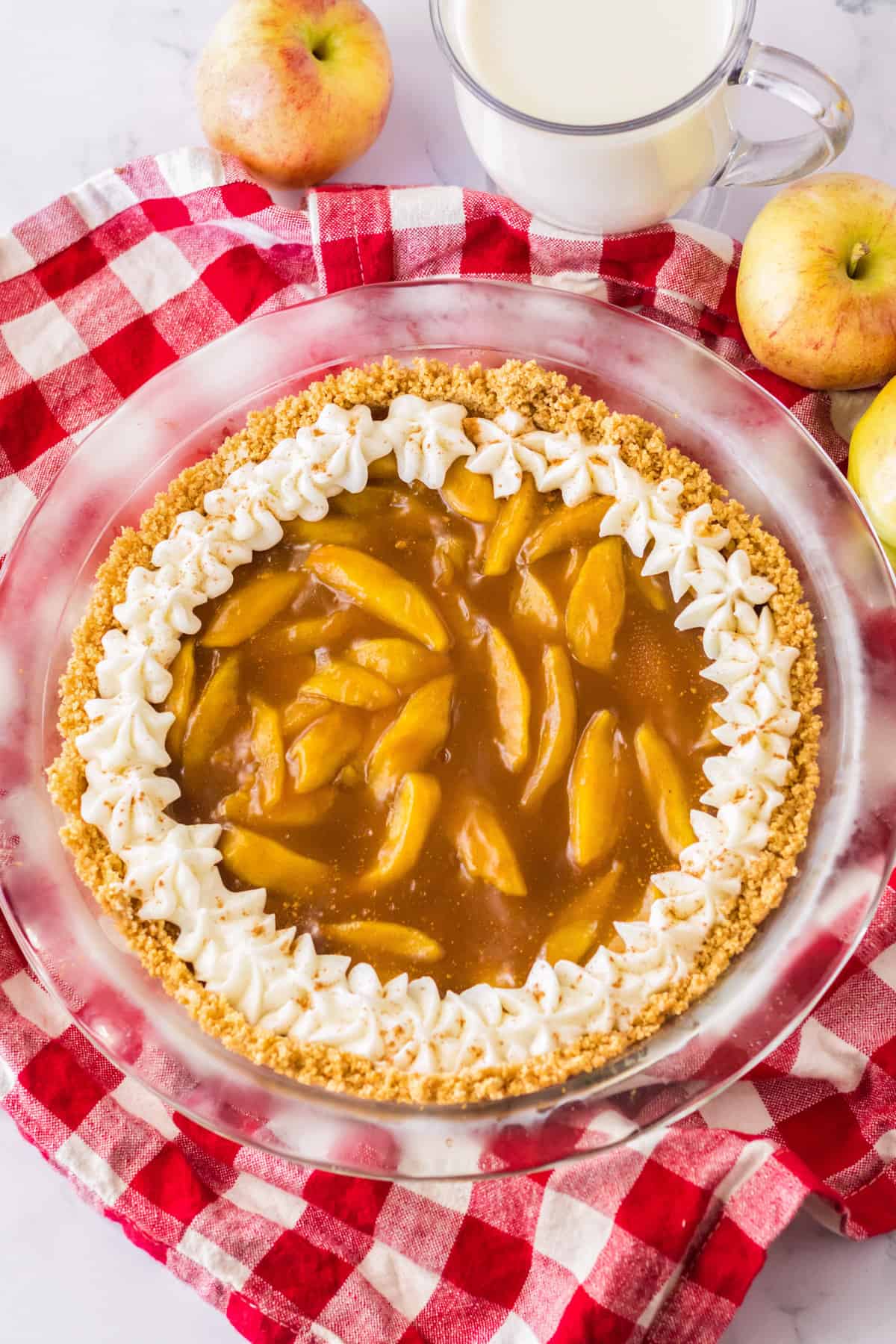 No bake apple pie with whipped cream piped around the perimeter.