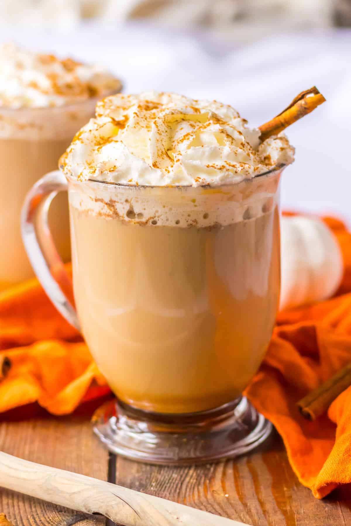 Crockpot Pumpkin Spice Latte topped with whipped cream, cinnamon, and a cinnamon stick.