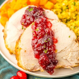 Sliced crock pot turkey roast with cranberry sauce.