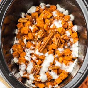 Crockpot sweet potato casserole with marshmallows and pecans.