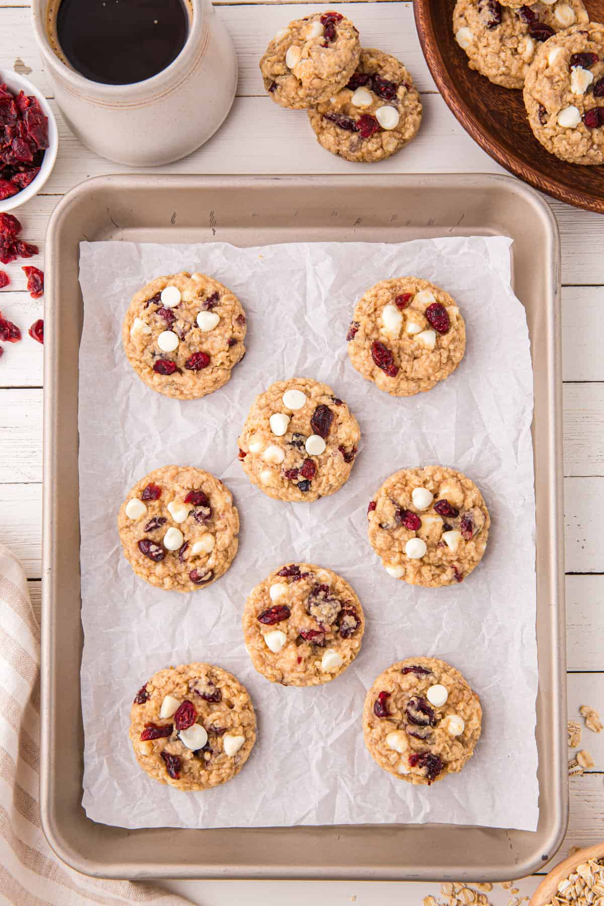 Baked white chocolate cranberry oatmeal cookies on baking sheet.