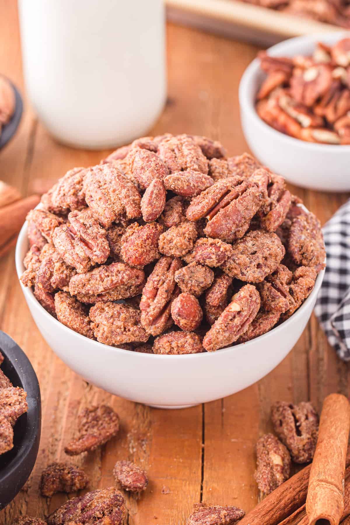 Candied pecans and almonds in a white bowl. 