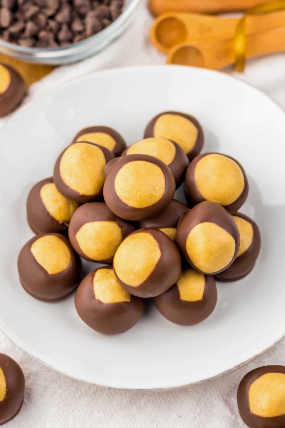 Overhead image of buckeye chocolate covered peanut butter balls served on a white plate.