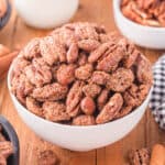 Candied pecans and almonds in a white bowl.