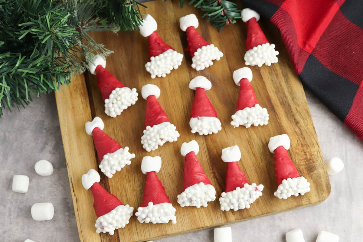 Bugles dipped in red chocolate and decorated with white spinkles and mini mashmallows to look like santa hats.