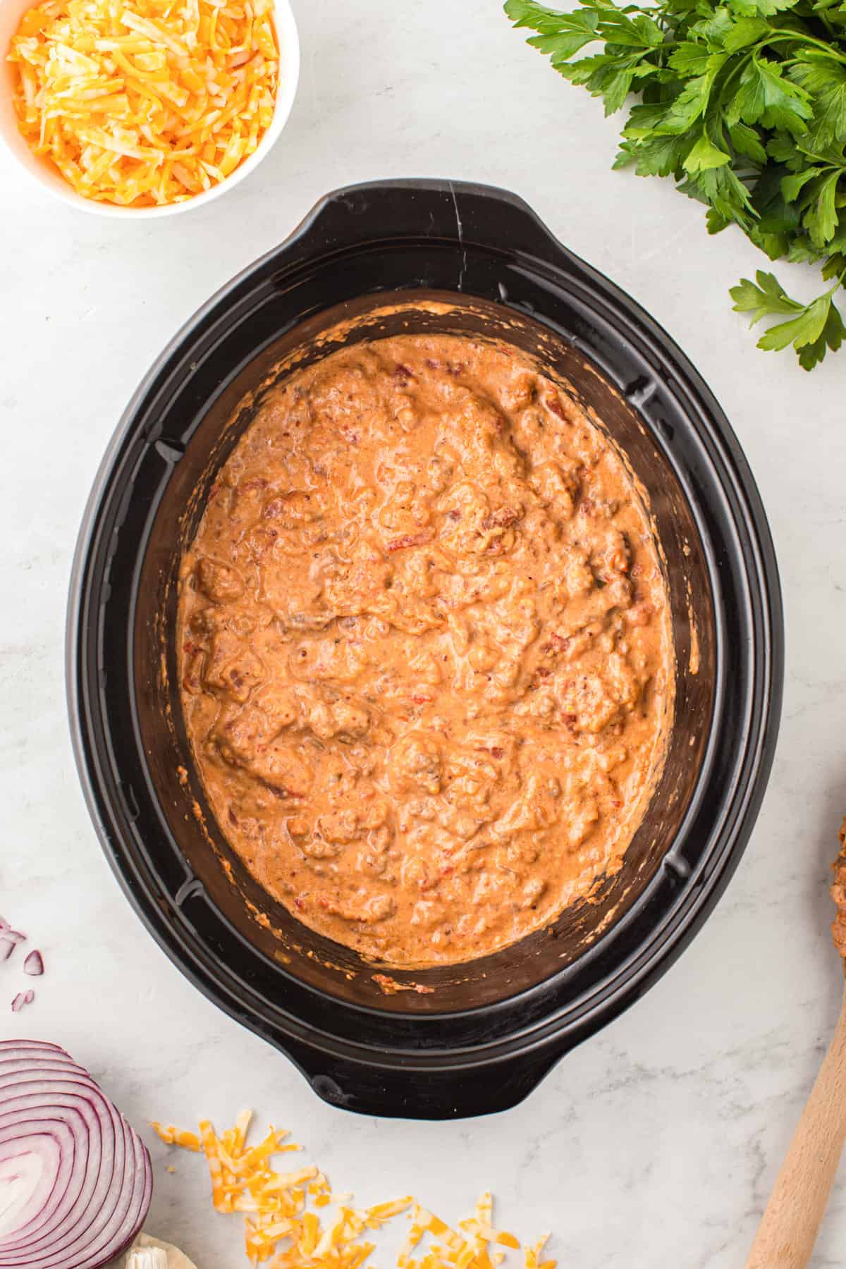 The cheesy burger dip after cooking and combining in the crockpot.