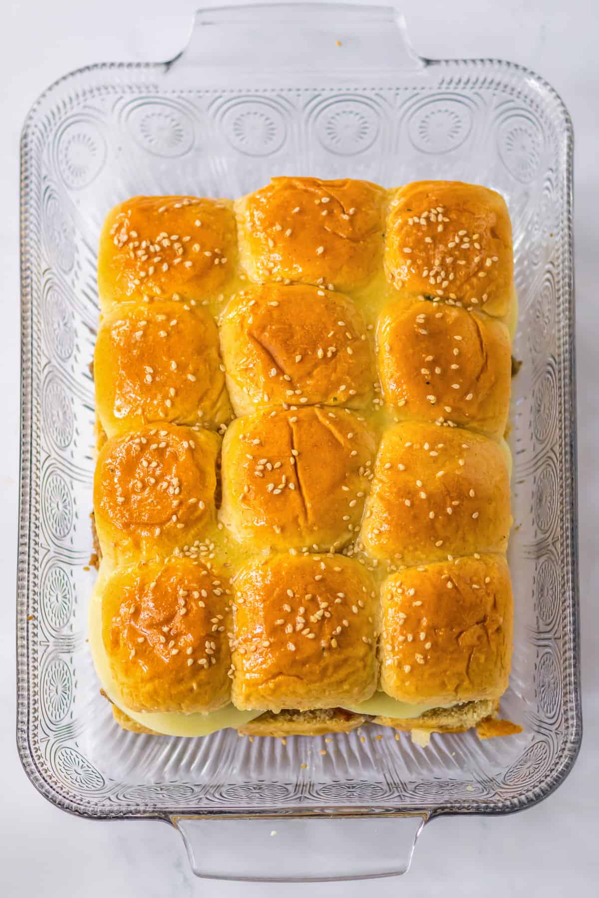 Slider buns with sesame seeds in 9 x 13 casserole dish.