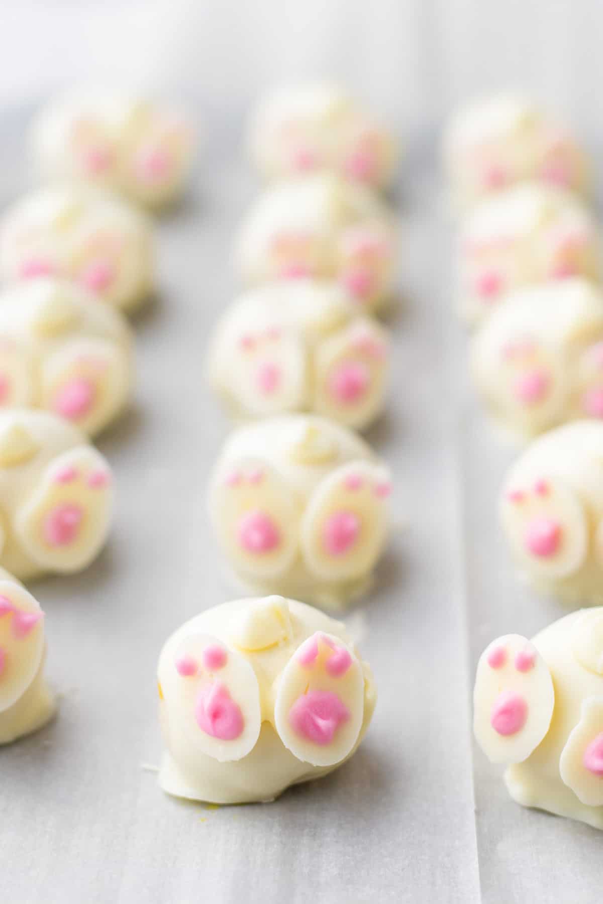 Easter Oreo balls decorated with feet and tails to look like bunny butts.