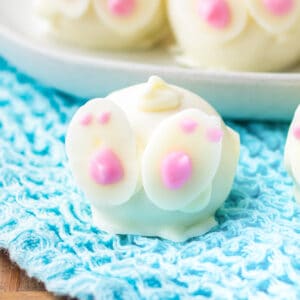 Oreo cookie truffles dipped in white chocolate and decorated with white chocolate feet and swirly tail to look like cute little bunny butts.