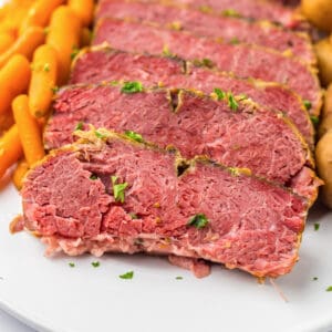 Tender and juicy crockpot corned beef brisket with baby potatoes and carrots.