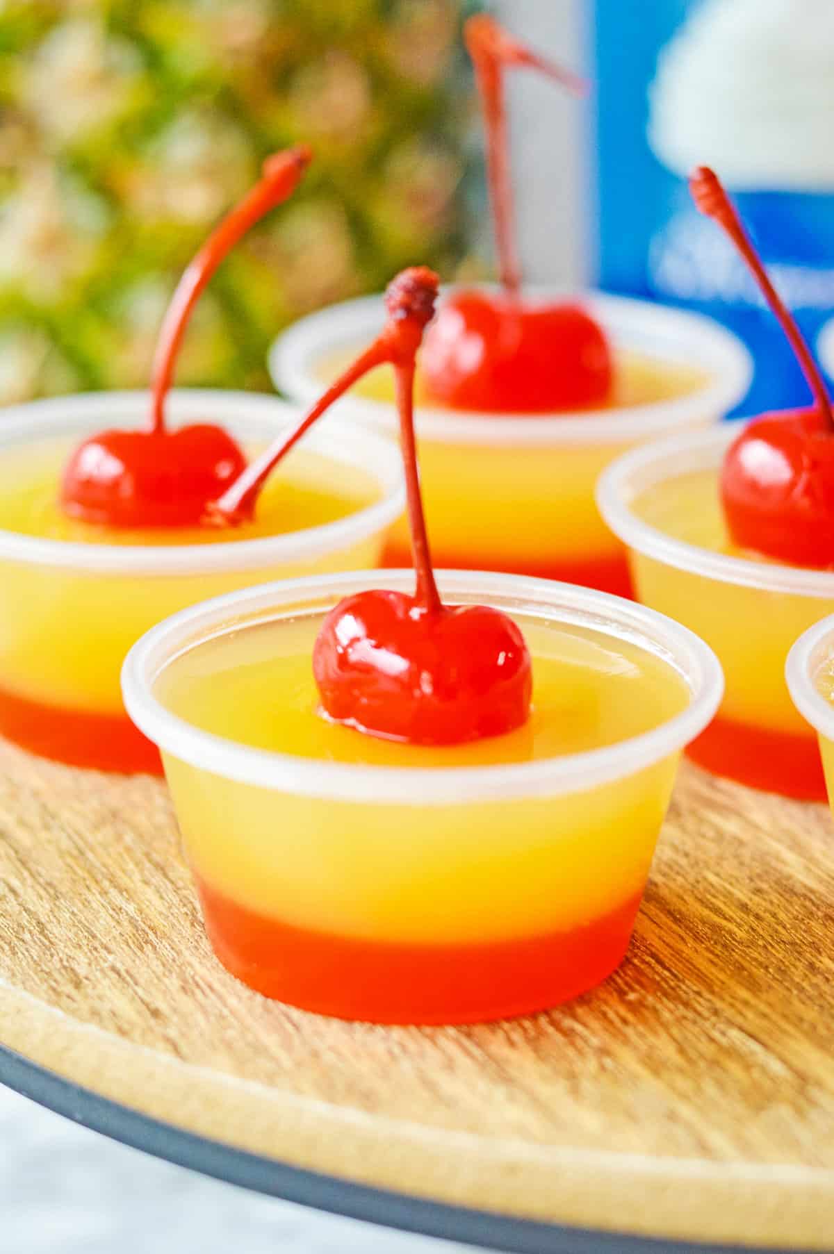 Cherry topped pineapple upside down jello shots.