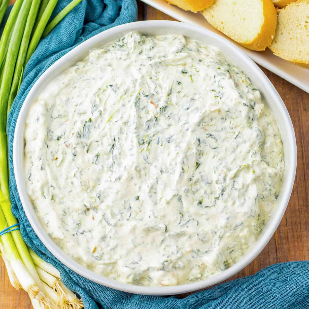 Cold and creamy Knorr spinach dip served with sliced bread pieces for dipping.