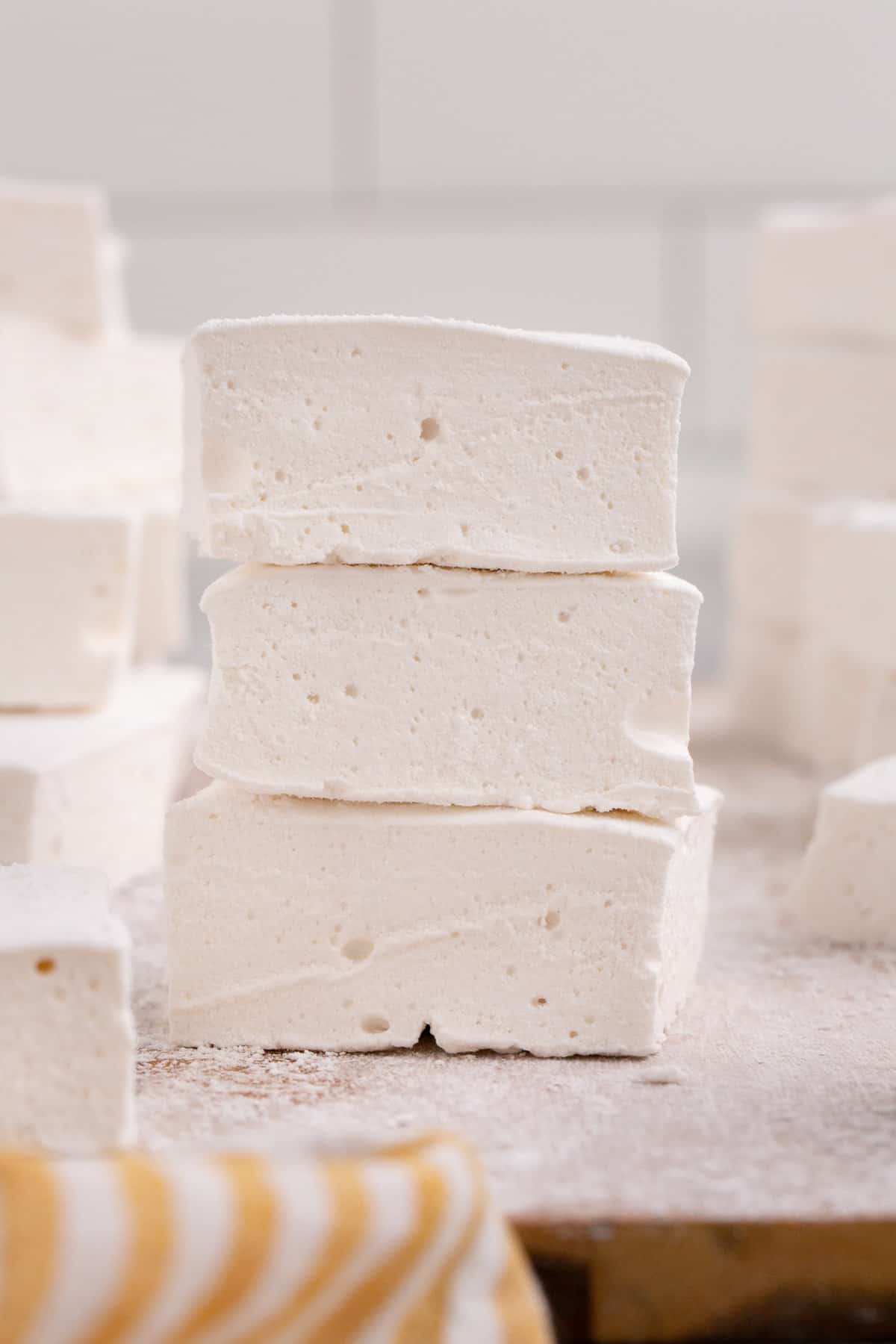 Soft and fluffy marshmallows stacked on top of one another, showing their light and airy texture.