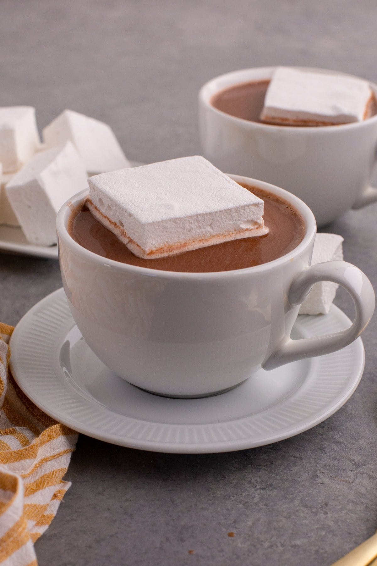 Cup of hot cocoa with large homemade marshmallow on top.