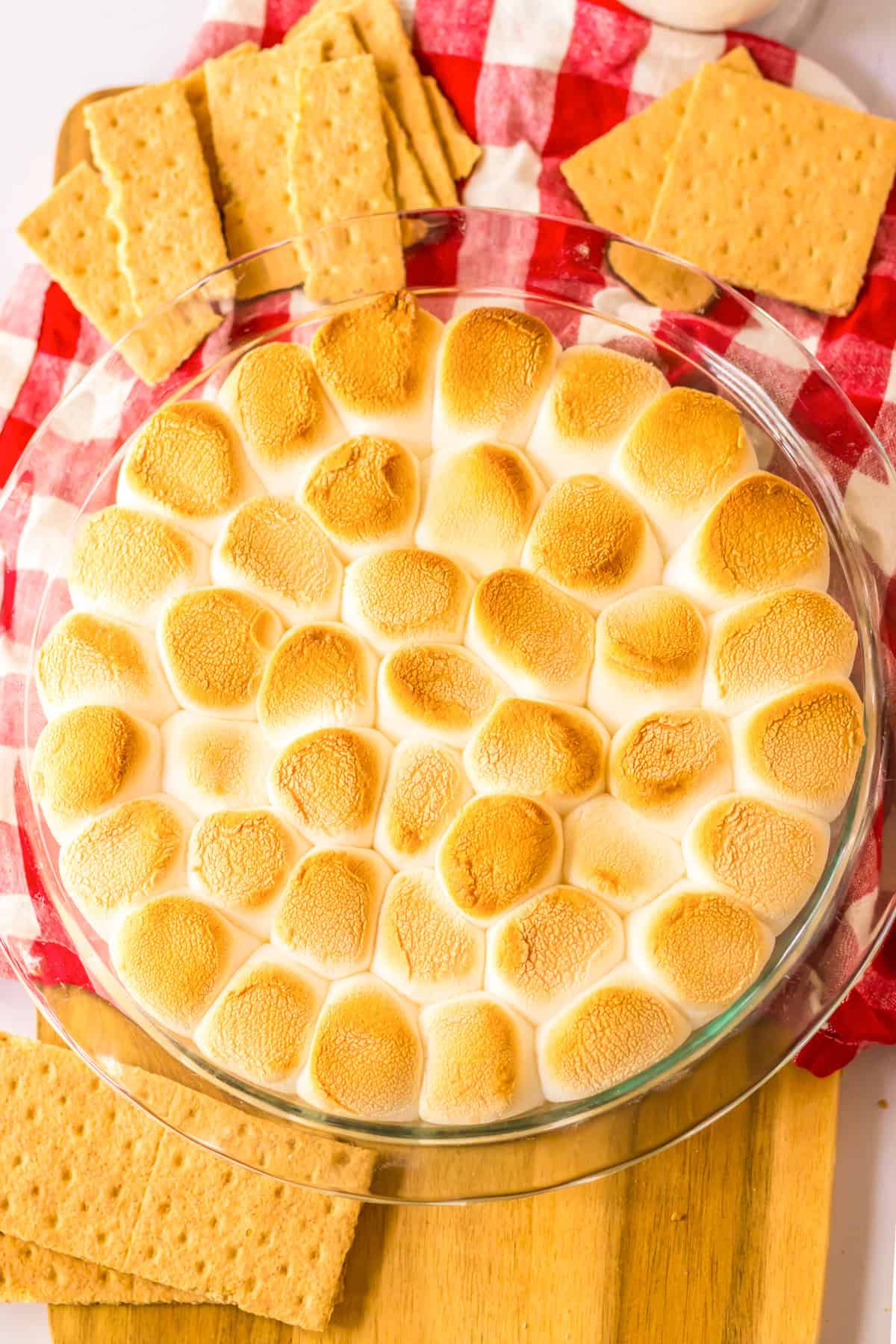 Baked S'mores dip in ground pie dish with graham crackers for dipping.