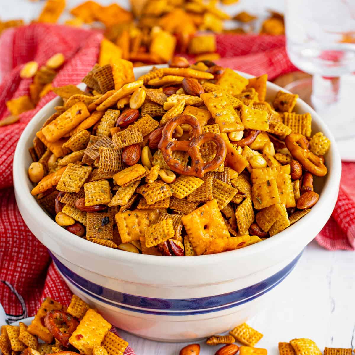 Firecracker spicy chex mix with pretzels, crackers, nuts, coated in a spicy ranch seasoning mix.