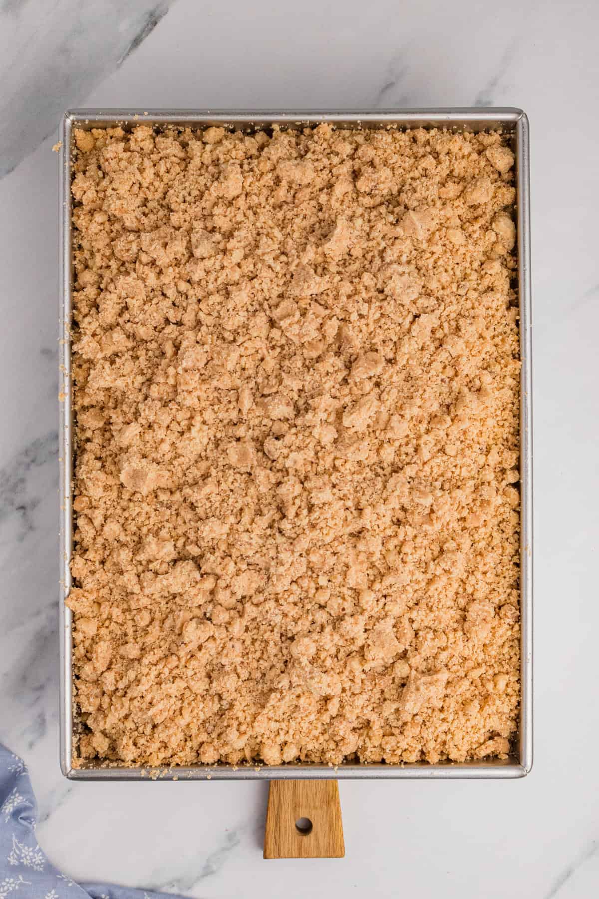 Overhead photo of 9 x 13 inch crumb cake in metal baking pan.