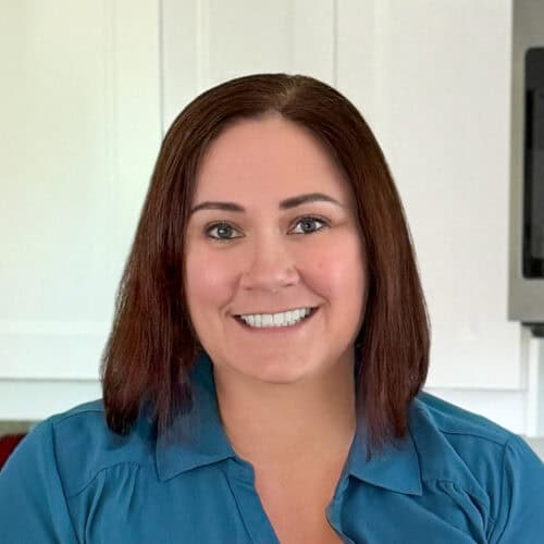 Headshot of Jaclyn Shimmel, recipe blogger at crayonsandcravings.com, smiling in her home kitchen.