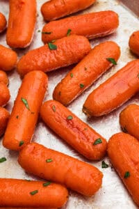 Brown sugar honey glazed carrots on metal sheet pan.