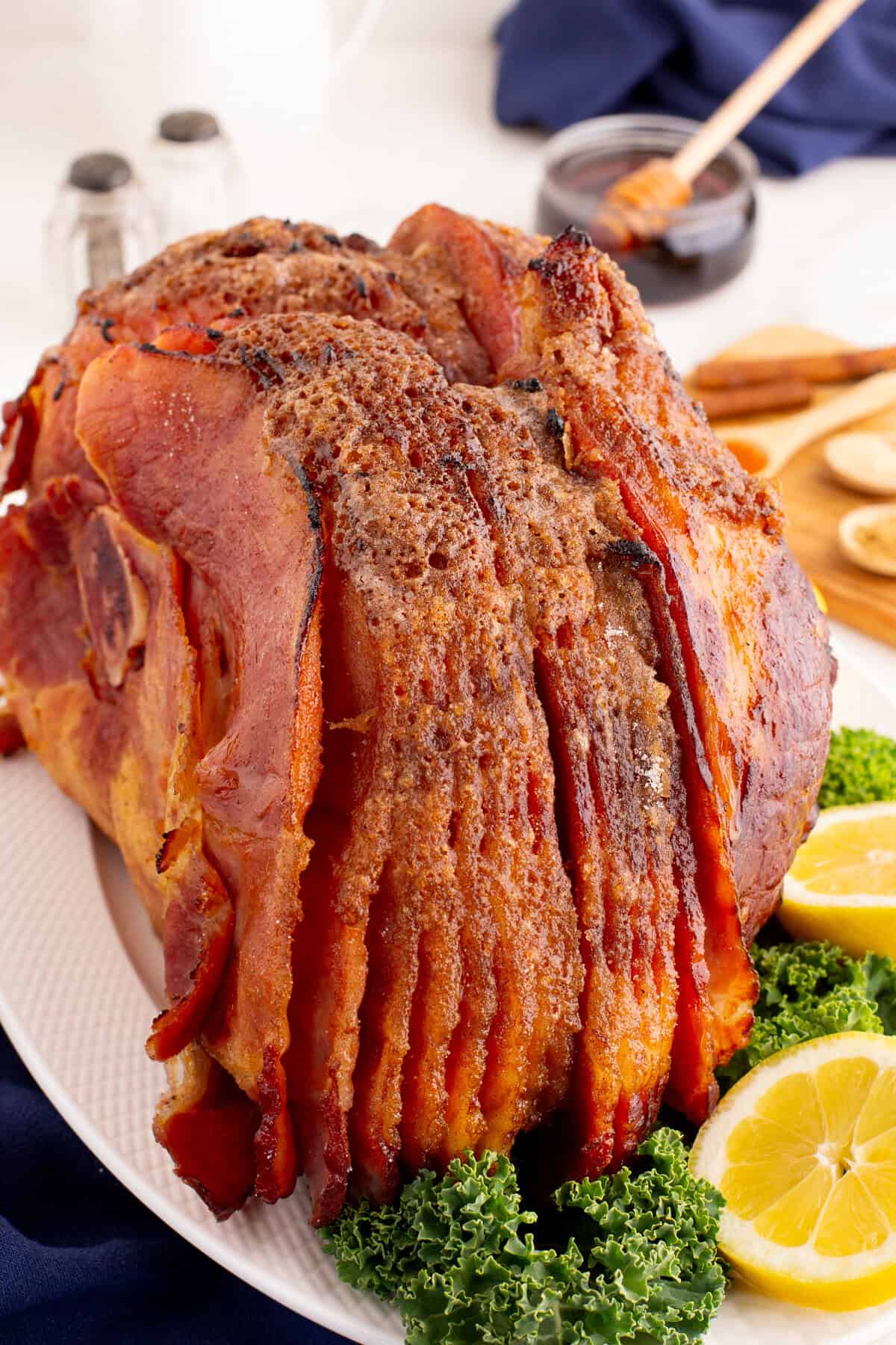 A baked spiral honey ham, highlighting its golden-brown crust and uniform spiral slices.