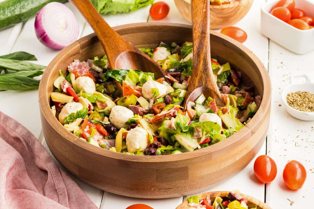 Chopped antipasti salad served in a wooden bowl.
