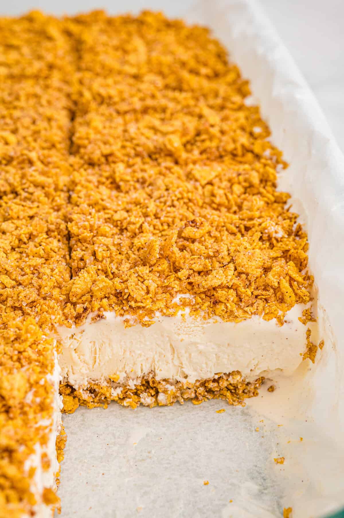Pan of sliced fried ice cream bars with golden cereal topping.