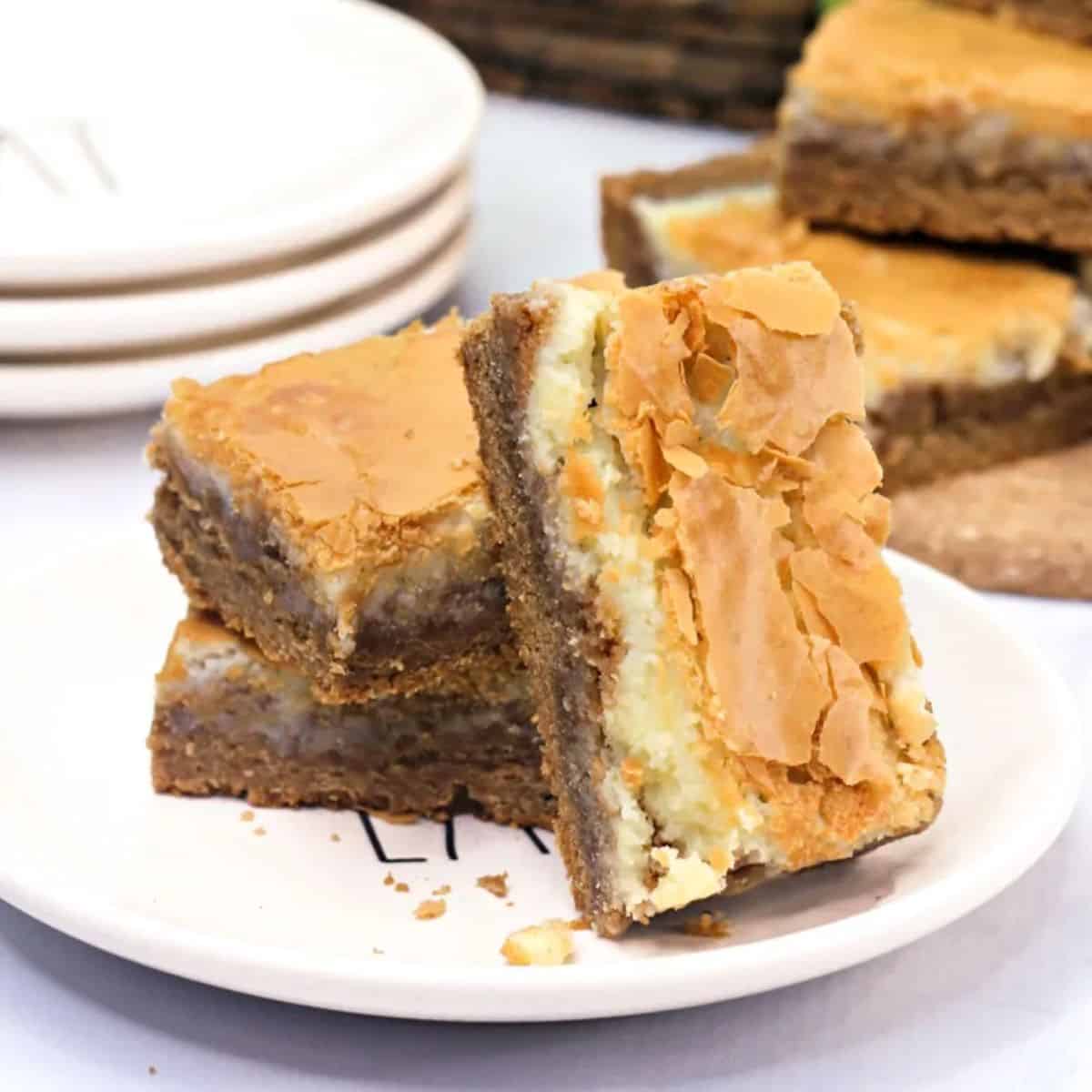 Harvest spice bars with layers of spice cookie, cream cheese, and a flakey crust.