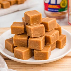 Stack of peanut butter fudge on a white plate.