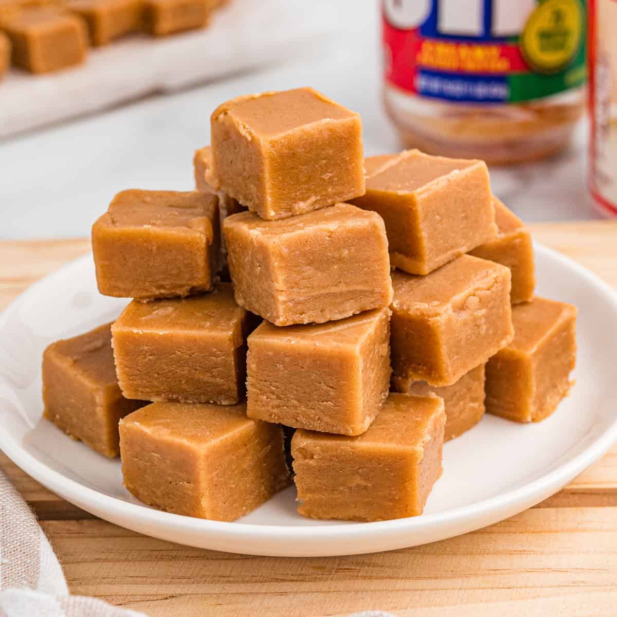 Stack of peanut butter fudge on a white plate.