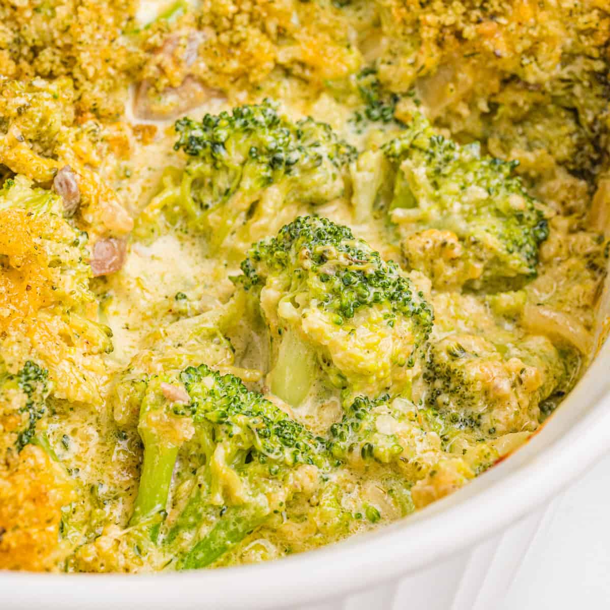 Broccoli casserole topped with golden panko breadcrumbs in a white baking dish.