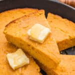 Slice of sweet potato cornbread with honey butter.