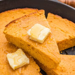 Slice of sweet potato cornbread with honey butter.