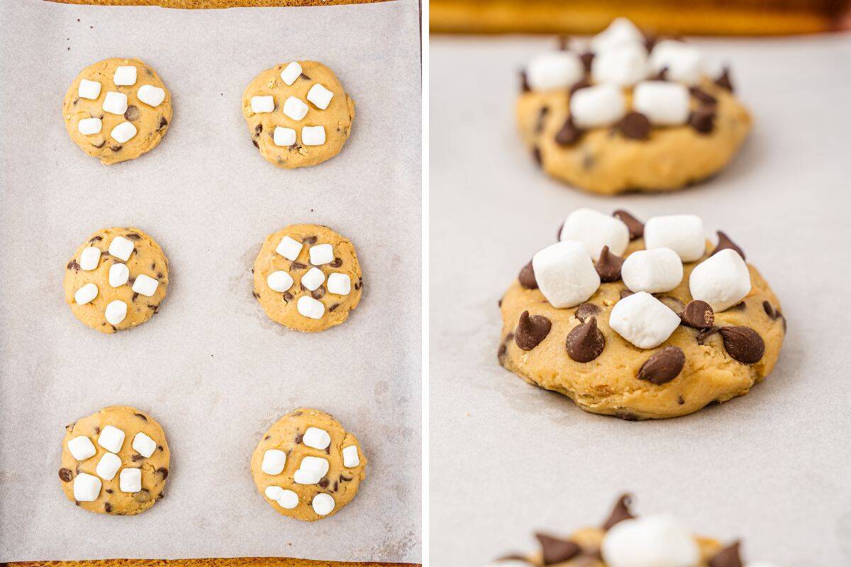 Unbaked s'mores cookie dough rounds topped with mini marshmallows and chocolate chips on parchment paper.