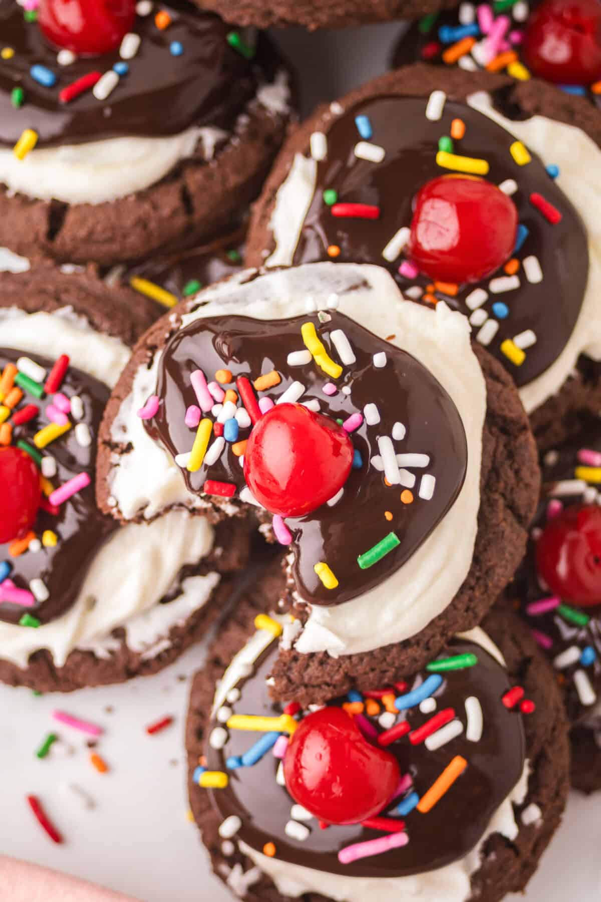 Close-up of hot fudge sundae cookies, one with a bite taken out.