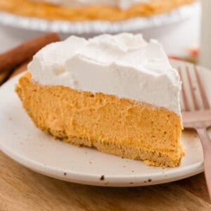 Slice of no-bake pumpkin pie on a plate with a fork.