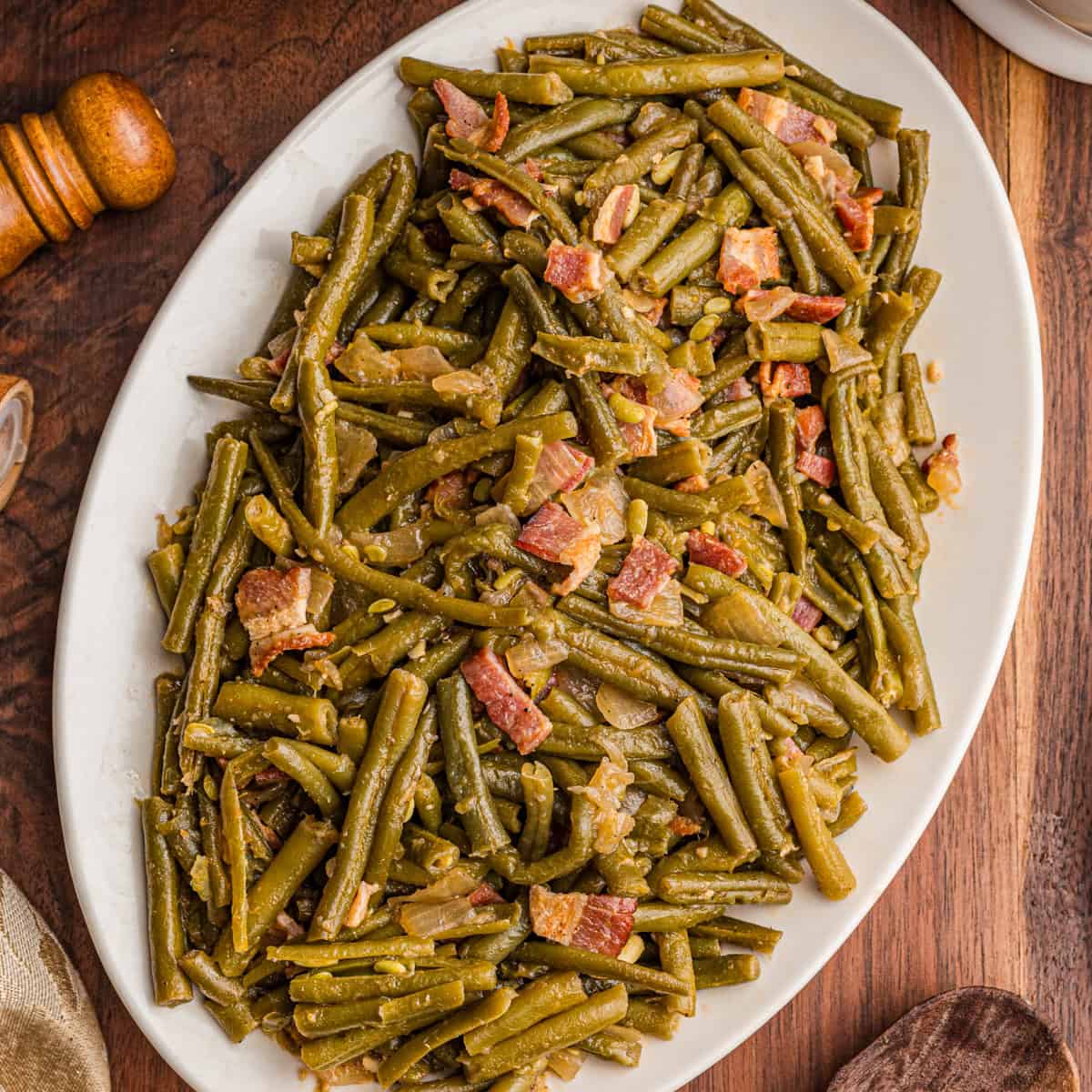 Southern green beans with bacon on a white serving platter.