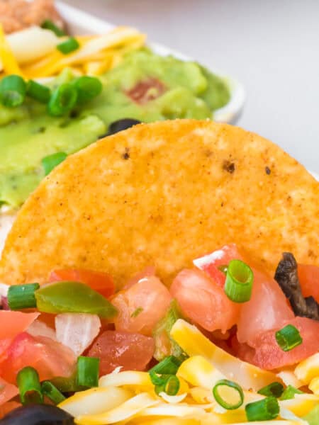 Tortilla chip dipped in taco Christmas dip.