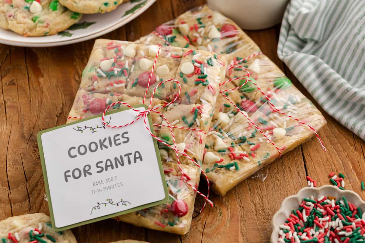 Wrapped Christmas cookie dough with M&Ms, white chocolate chips, and sprinkles, labeled “Cookies for Santa.”