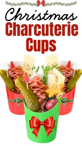 Red and green gharcuterie cups filled with salami, cheddar cheese stars, gherkins, grapes, rosemary, and crackers. Text at the top reads "Christmas Charcuterie Cups".