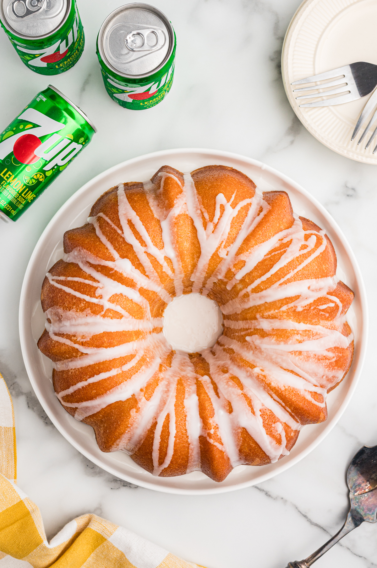 Overhead view of a golden brown 7 Up pound cake with white glaze drizzled over the top.