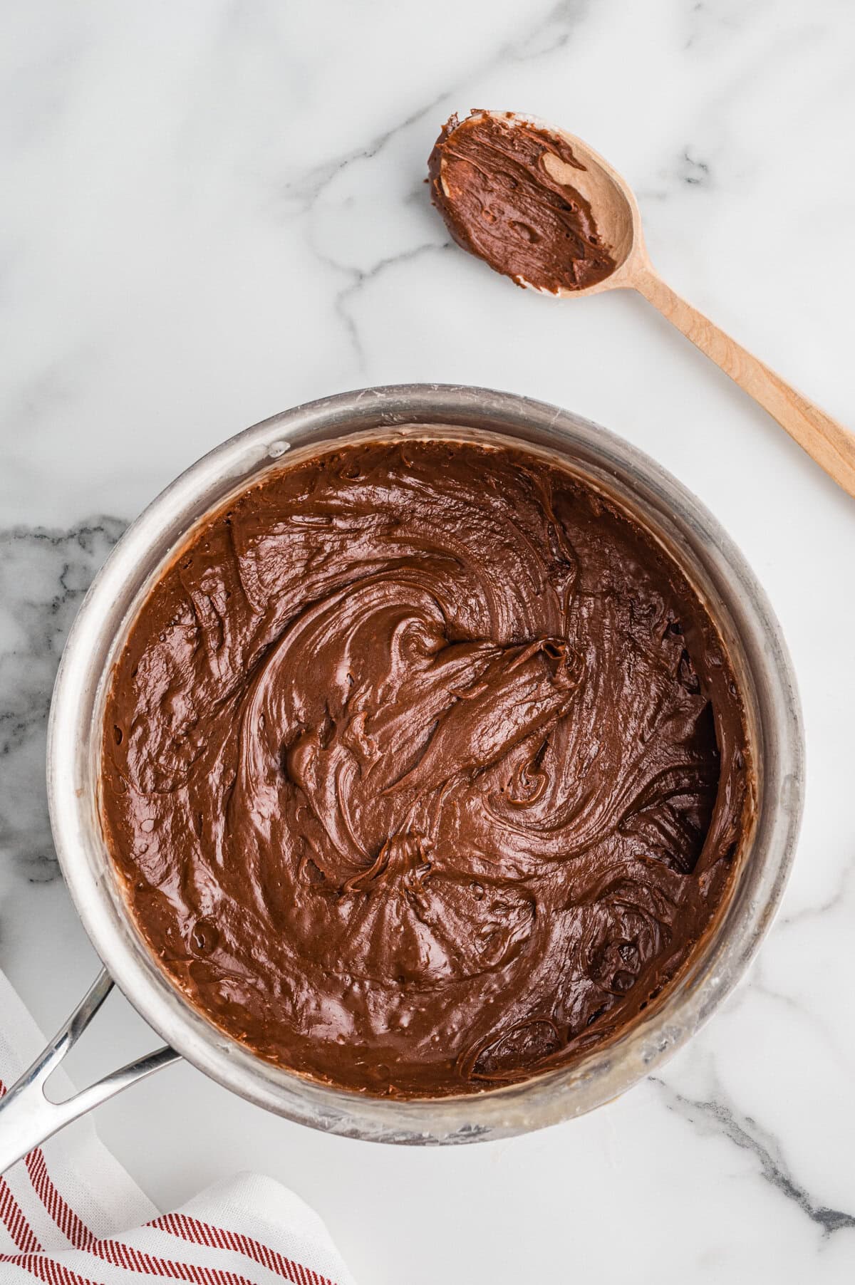 Thick chocolate fudge mixture in a saucepan.