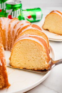Slice of 7 Up pound cake lifted from the whole cake.